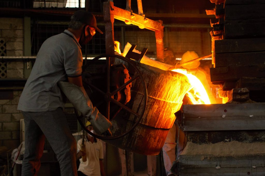 Furnace operator pouring molten steel at the Trieka Aimex foundry